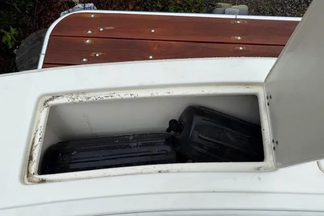 Slide: The Image of 2005 Albemarle 248 Express Fisherman storage compartment with wooden deck detail. - 16
