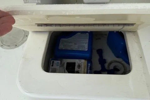 Slide: The Image of Storage compartment on a 2005 Albemarle 248 Express Fisherman boat, containing supplies. - 19