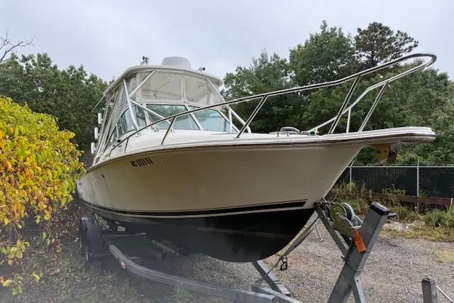 Slide: The Image of 2005 Albemarle 248 Express Fisherman boat on trailer, surrounded by greenery. - 2