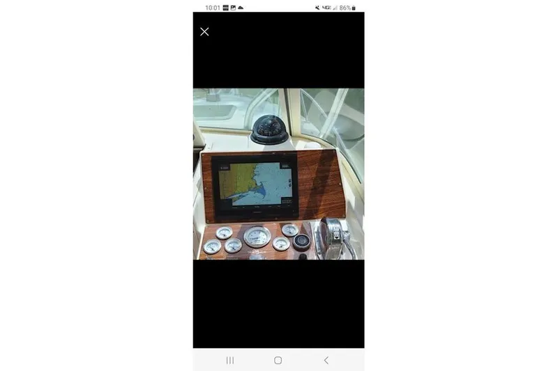 Slide: The Image of 2005 Albemarle 248 Express Fisherman boat interior with marine toilet and starfish-patterned bedding. - 25