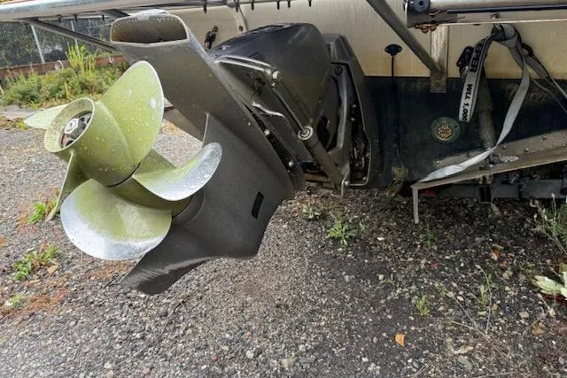 Slide: The Image of 2005 Albemarle 248 Express Fisherman boat propeller on gravel surface. - 3