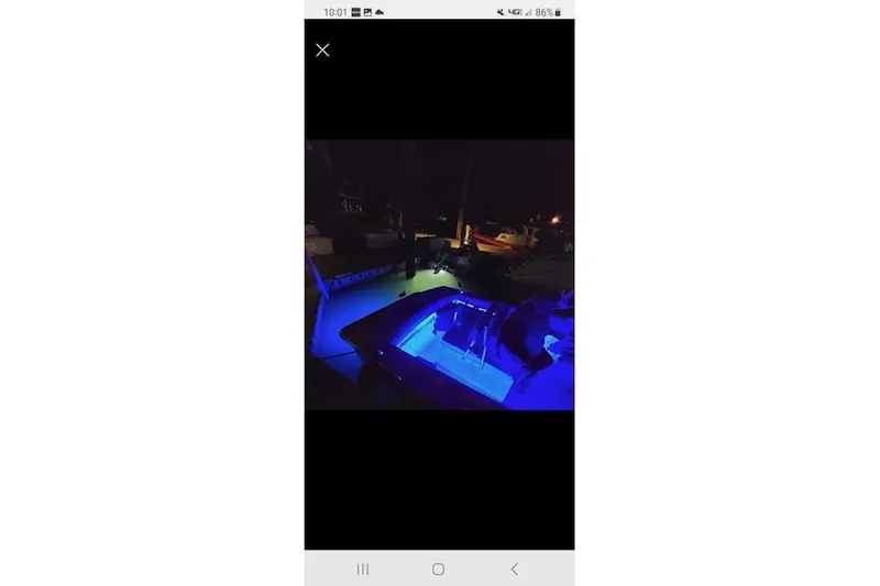 Slide: The Image of 2005 Albemarle 248 Express Fisherman boat illuminated with blue lights at night. - 32