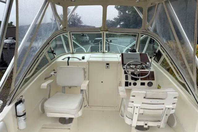 Slide: The Image of 2005 Albemarle 248 Express Fisherman boat interior with steering wheel and seating. - 7