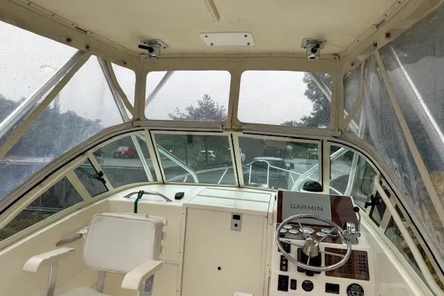 Slide: The Image of 2005 Albemarle 248 Express Fisherman boat interior with steering wheel and Garmin navigation system. - 8