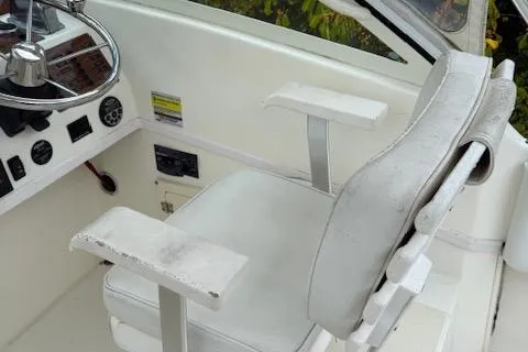 Slide: The Image of 2005 Albemarle 248 Express Fisherman boat cockpit with steering wheel and white captain's chair. - 9