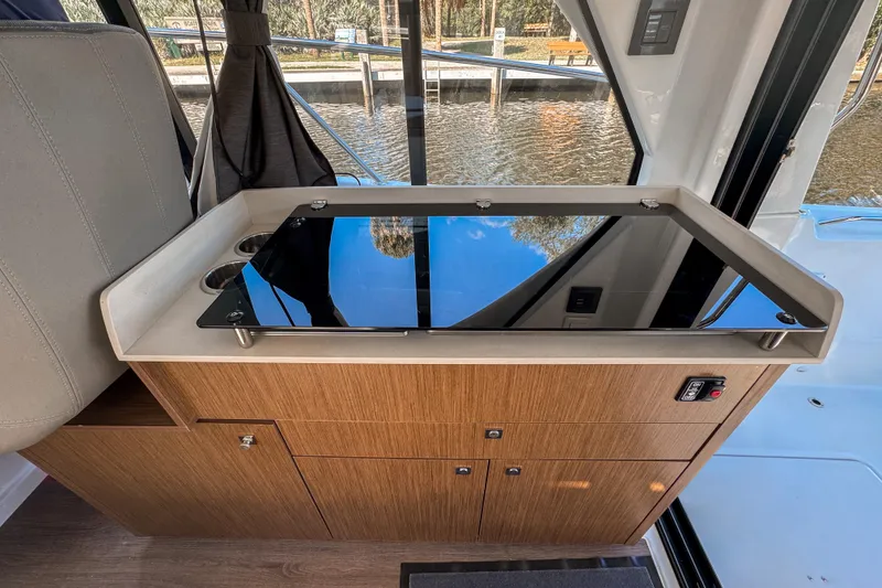 Slide: The Image of 2025 Beneteau Antares 9 interior with sleek wooden cabinetry and modern design. - 11