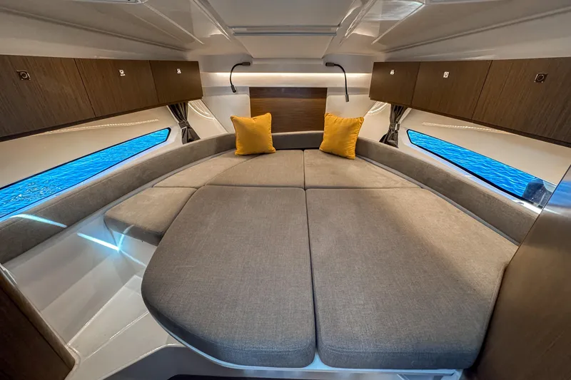 Slide: The Image of Luxurious interior of 2025 Beneteau Antares 9 with cozy bedding and modern design. - 20