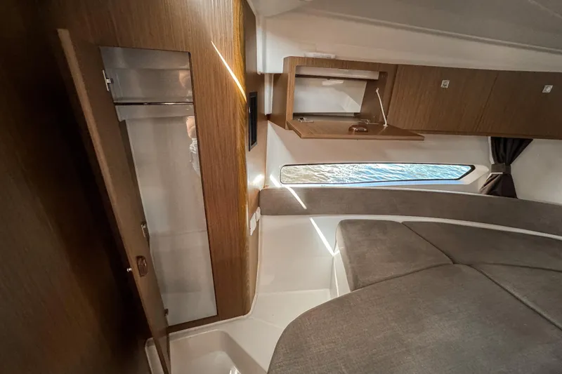 Slide: The Image of 2025 Beneteau Antares 9 cabin interior with wood finish and modern design. - 22