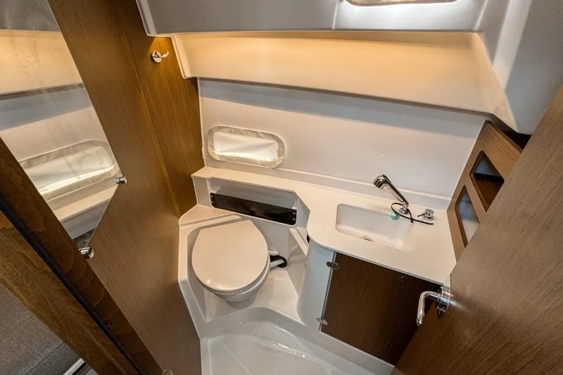 Slide: The Image of 2025 Beneteau Antares 9 bathroom interior with modern fixtures and wood accents. - 25