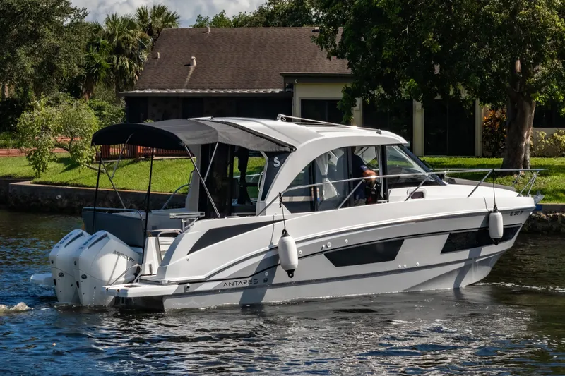Slide: The Image of 2025 Beneteau Antares 9 motorboat cruising on a scenic waterway. - 26