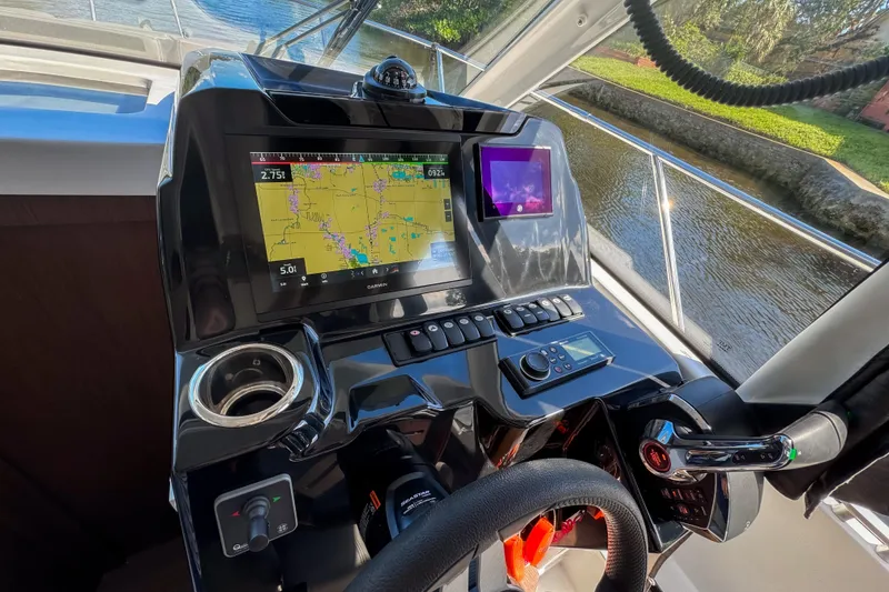 Slide: The Image of Helm of 2025 Beneteau Antares 9 with navigation screens and controls. - 9