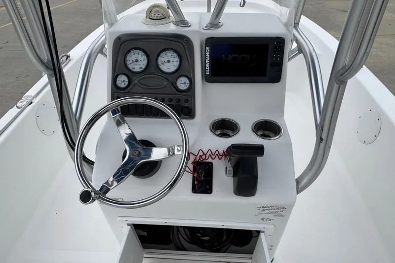 Slide: The Image of 2015 Tidewater 1800 Bay Max boat console with steering wheel and navigation instruments. - 10