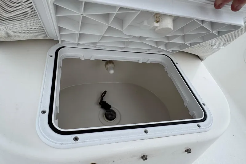 Slide: The Image of Open storage compartment on 2015 Tidewater 1800 Bay Max boat, showing interior details. - 12
