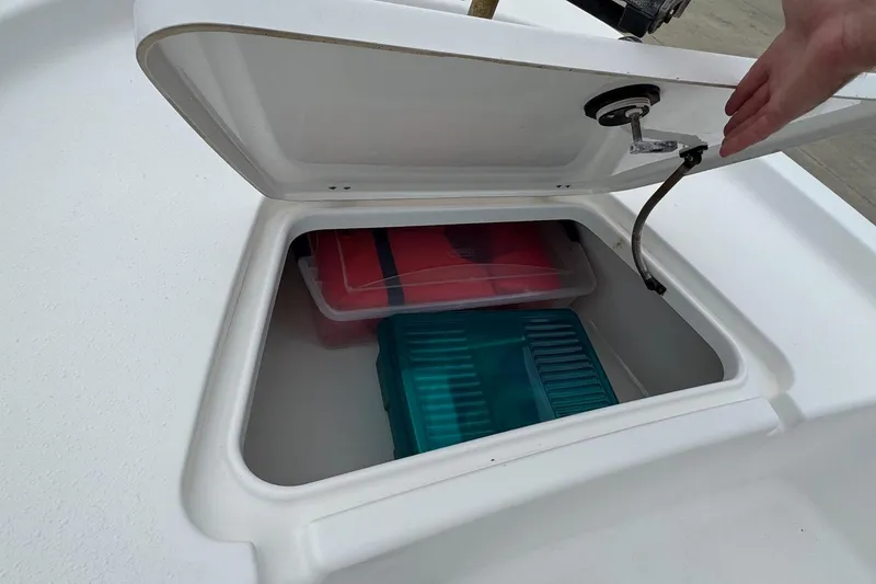 Slide: The Image of Open storage compartment on 2015 Tidewater 1800 Bay Max boat with containers inside. - 14