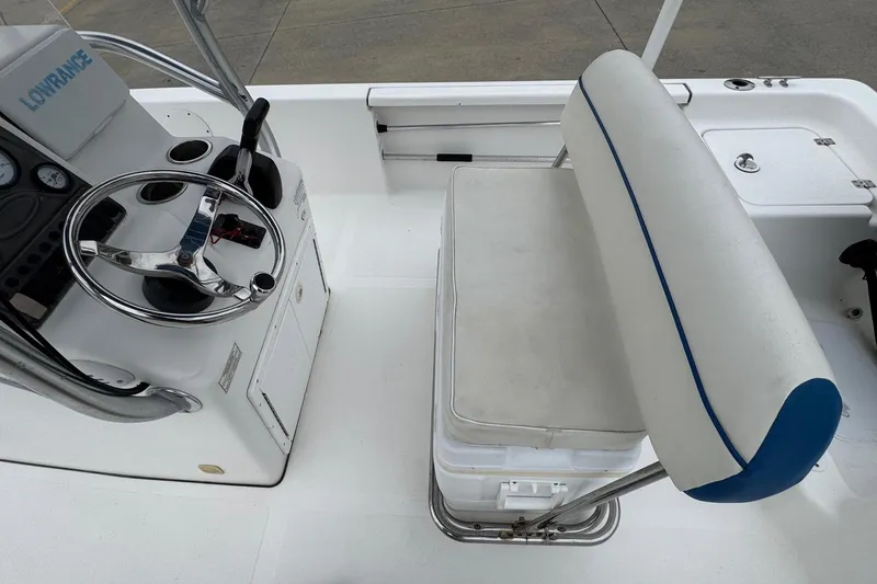 Slide: The Image of 2015 Tidewater 1800 Bay Max boat interior with steering console and cushioned seating. - 17