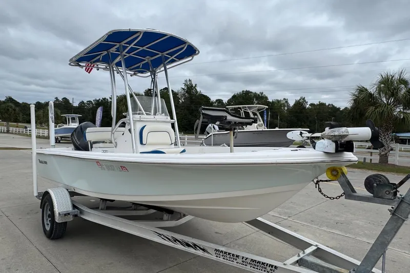 Slide: The Image of 2015 Tidewater 1800 Bay Max boat on trailer, featuring blue canopy and white hull. - 6
