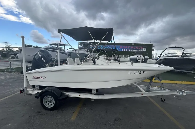 The Image of 2011 Boston Whaler 160 Super Sport boat on trailer under cloudy sky. - 0