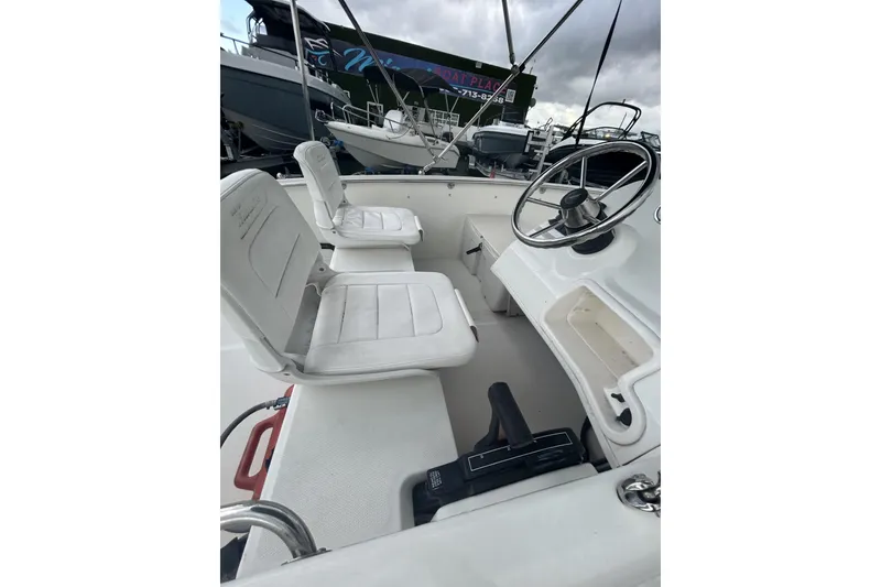 Slide: The Image of 2011 Boston Whaler 160 Super Sport interior with steering wheel and seating. - 18