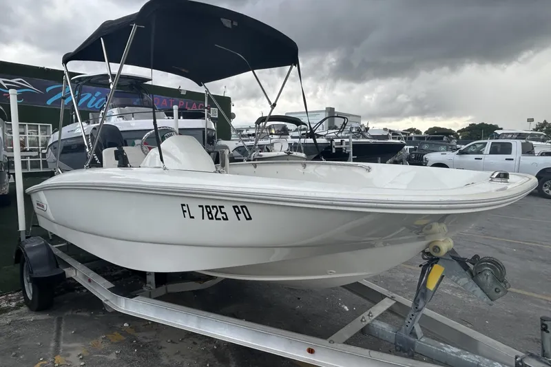 Slide: The Image of 2011 Boston Whaler 160 Super Sport boat on trailer under cloudy sky. - 23
