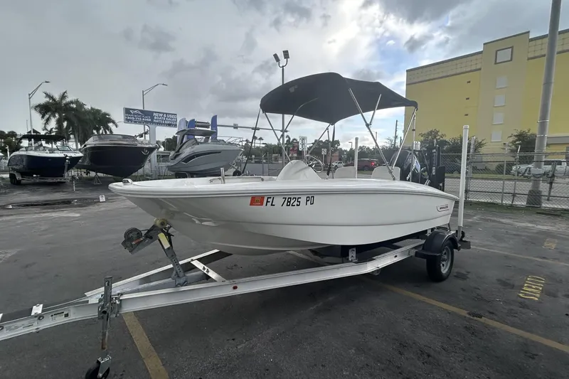 Slide: The Image of 2011 Boston Whaler 160 Super Sport boat on trailer, parked outdoors. - 3