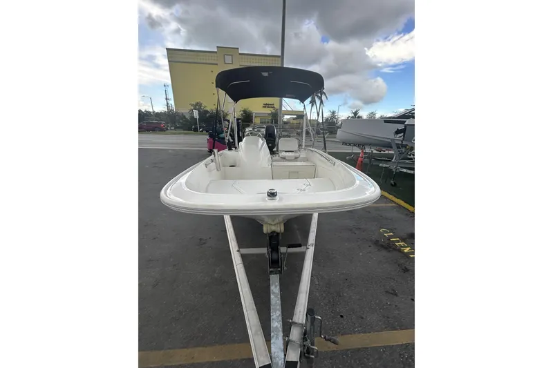 Slide: The Image of 2011 Boston Whaler 160 Super Sport boat on trailer, parked outdoors. - 4