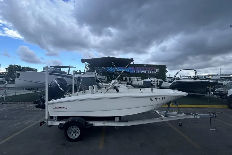 Slide: The Image of 2011 Boston Whaler 160 Super Sport boat on trailer under cloudy sky. - 6