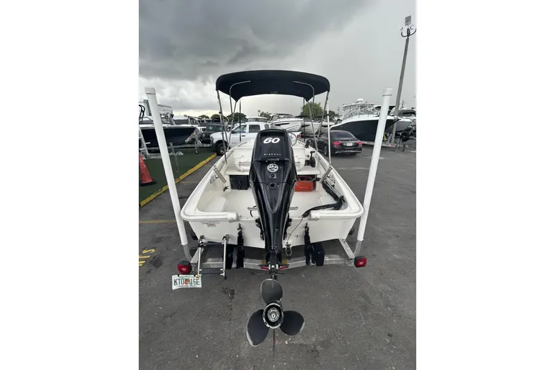 Slide: The Image of 2011 Boston Whaler 160 Super Sport boat with outboard motor, parked on trailer. - 8