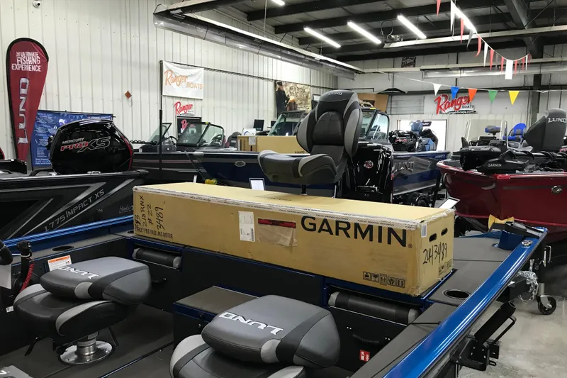 Slide: The Image of 2026 Lund 1875 Renegade boat, blue exterior, sleek design, in showroom setting. - 10