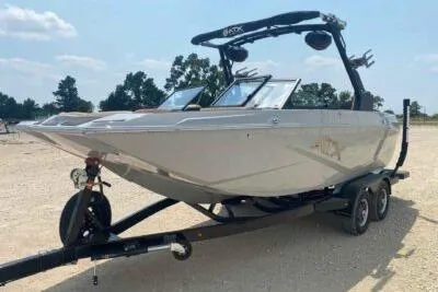 Slide: The Image of 2026 ATX Surf Boats 20 Type-S on trailer, parked outdoors. - 2