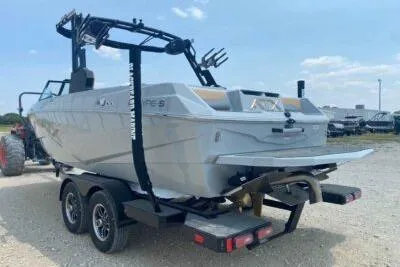 Slide: The Image of 2026 ATX Surf Boats 20 Type-S on trailer, rear view, outdoors. - 4