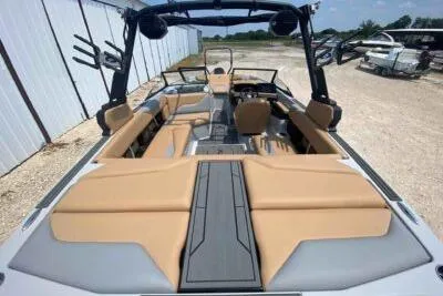 Slide: The Image of 2026 ATX Surf Boats 20 Type-S with tan interior, docked outdoors. - 6