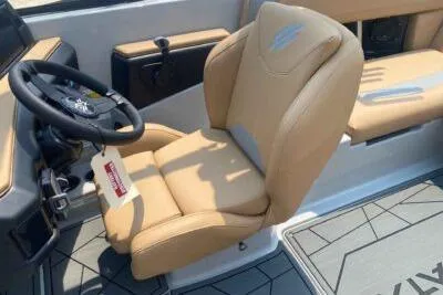 Slide: The Image of 2026 ATX Surf Boats 20 Type-S interior with tan seating and modern steering wheel. - 8