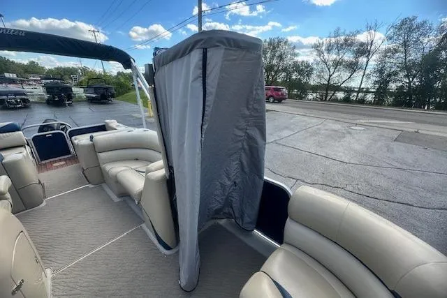 Slide: The Image of 2014 Manitou 24 Oasis SR pontoon boat interior with seating and privacy curtain. - 21
