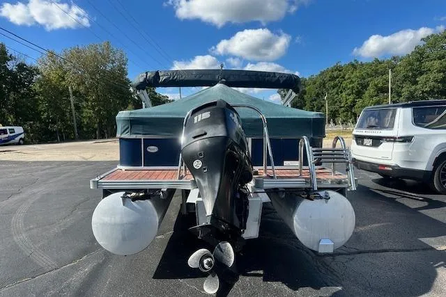 Slide: The Image of 2014 Manitou 24 Oasis SR pontoon boat with 115 HP engine, parked outdoors. - 30