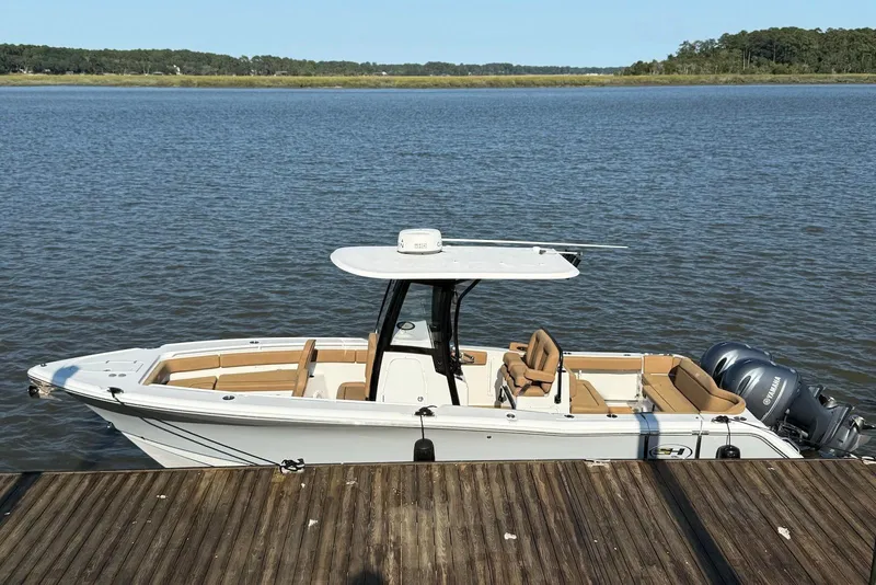 The Image of 2022 Sea Hunt Ultra 275 SE boat docked on calm water. - 0