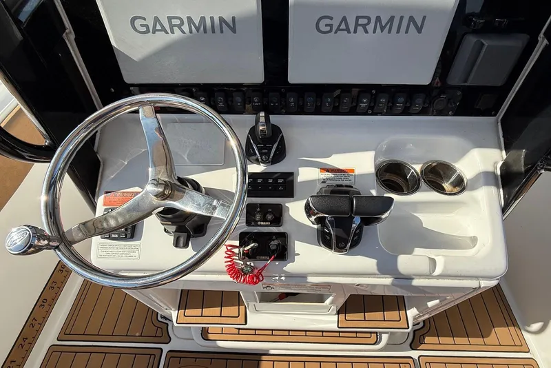 Slide: The Image of 2022 Sea Hunt Ultra 275 SE helm with Garmin displays and steering wheel. - 10