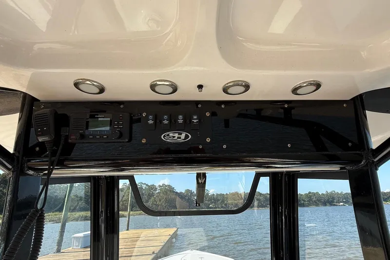 Slide: The Image of 2022 Sea Hunt Ultra 275 SE boat console with Garmin electronics and scenic water view. - 11