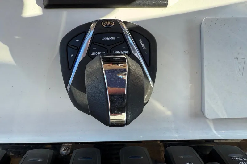Slide: The Image of Boat control panel of a 2022 Sea Hunt Ultra 275 SE, featuring joystick and buttons. - 12