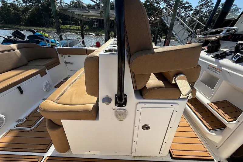 Slide: The Image of 2022 Sea Hunt Ultra 275 SE boat interior with tan seating and wood accents. - 13