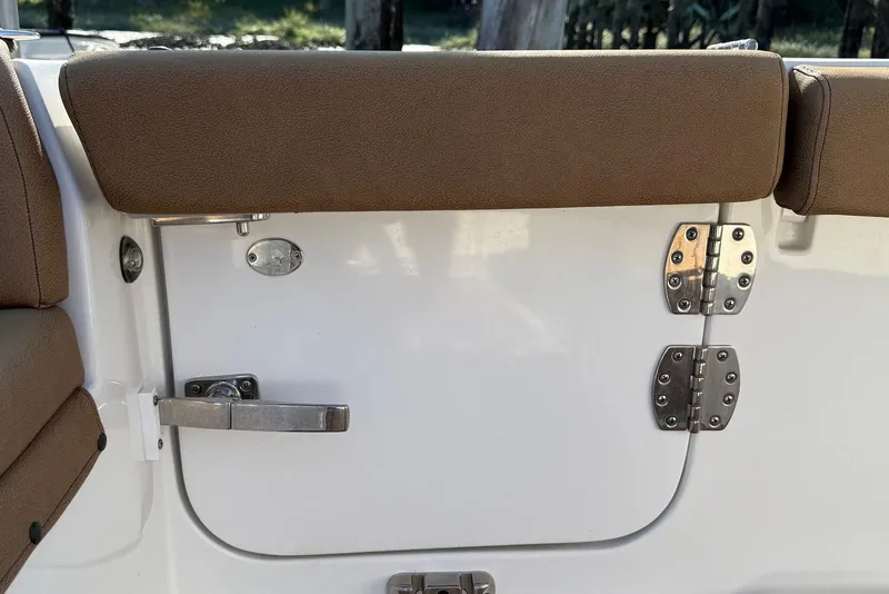 Slide: The Image of 2022 Sea Hunt Ultra 275 SE boat interior with brown cushioned seating and stainless steel hardware. - 15