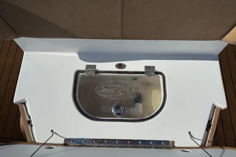 Slide: The Image of 2022 Sea Hunt Ultra 275 SE boat deck with storage compartment. - 26