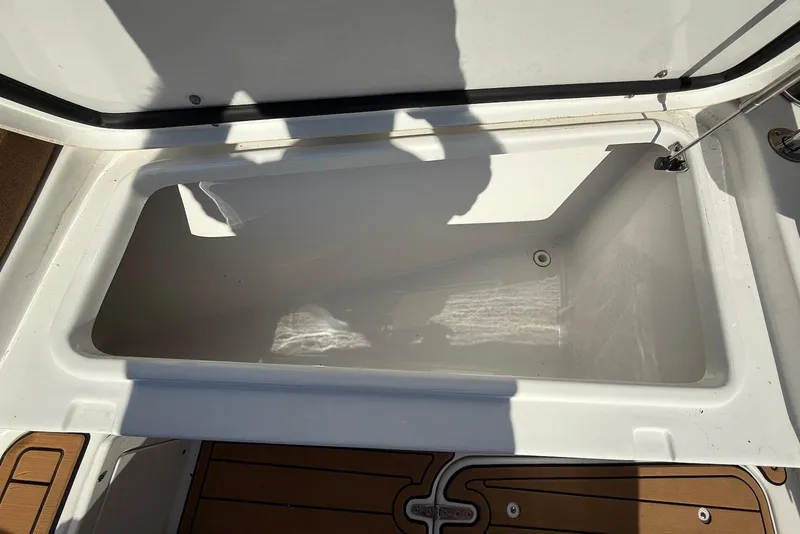 Slide: The Image of Open storage compartment on 2022 Sea Hunt Ultra 275 SE boat. - 27