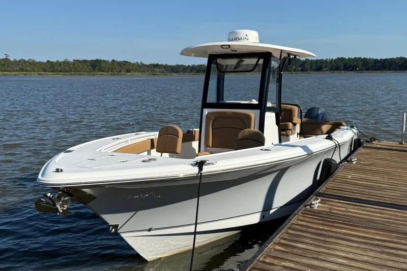 Slide: The Image of 2022 Sea Hunt Ultra 275 SE boat docked on a calm lake. - 3