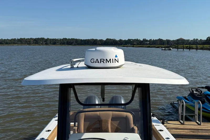 Slide: The Image of 2022 Sea Hunt Ultra 275 SE boat with Garmin radar on calm water. - 5