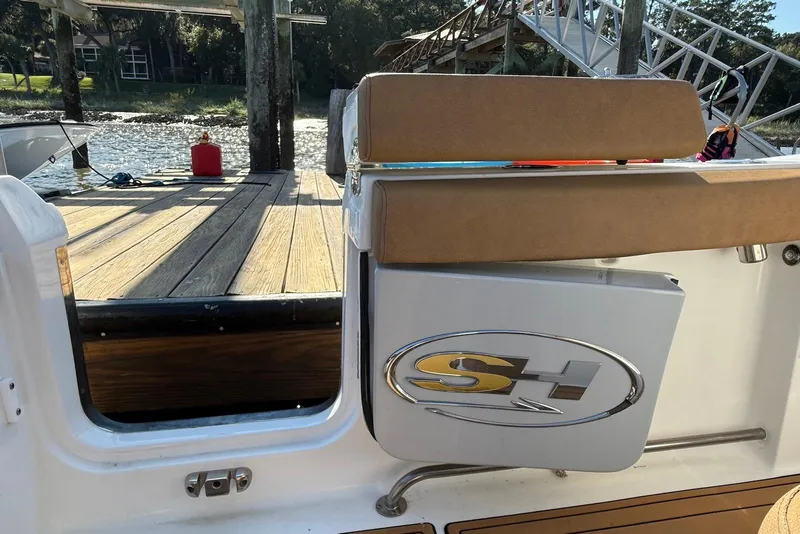 Slide: The Image of 2022 Sea Hunt Ultra 275 SE boat at dock with open gate and logo visible. - 8