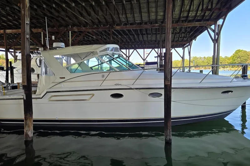 The Image of 1996 Tiara Yachts 3700 Open cruising on a calm lake with forested shoreline. - 0