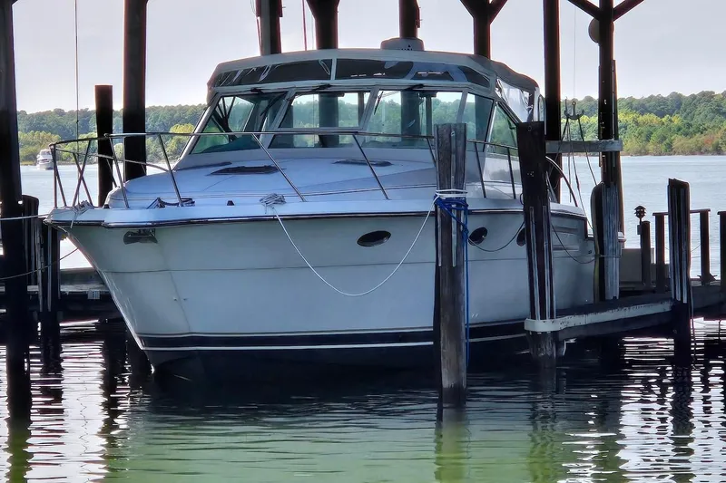 Slide: The Image of 1996 Tiara Yachts 3700 Open docked in a covered marina, side view. - 10
