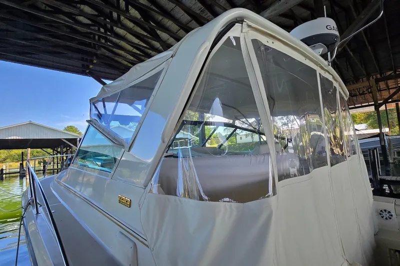 Slide: The Image of 1996 Tiara Yachts 3700 Open docked under wooden shelter. - 12