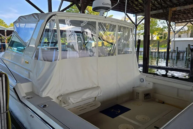 Slide: The Image of 1996 Tiara Yachts 3700 Open docked, showcasing sleek design and sturdy build. - 13