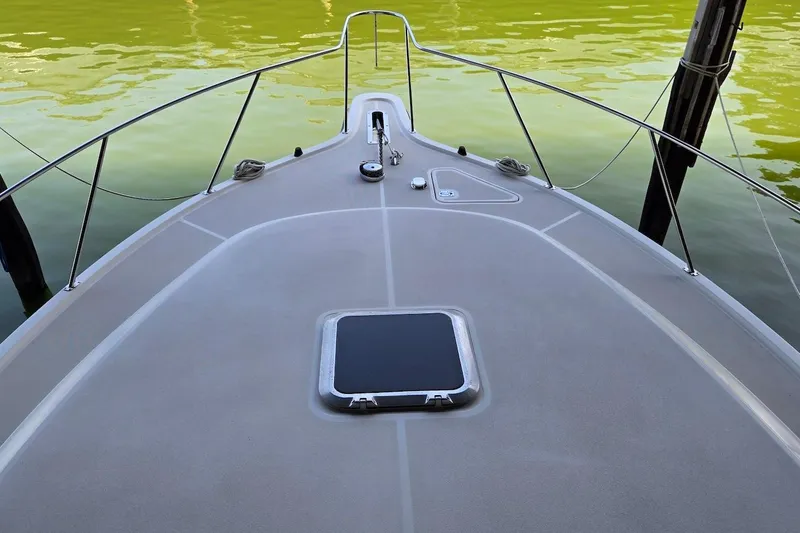 Slide: The Image of 1996 Tiara Yachts 3700 Open docked, showcasing sleek design and sturdy build. - 15